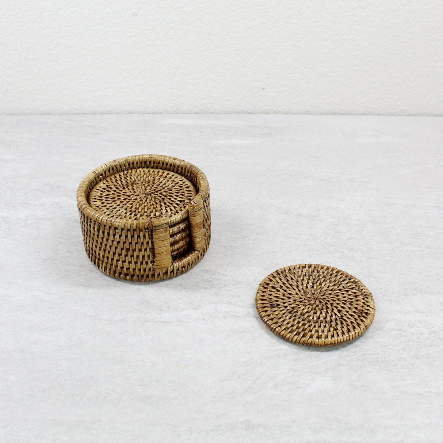 ECO HANDCRAFT handmade brown rattan coaster set with holder, perfect for stylish and sustainable table protection.