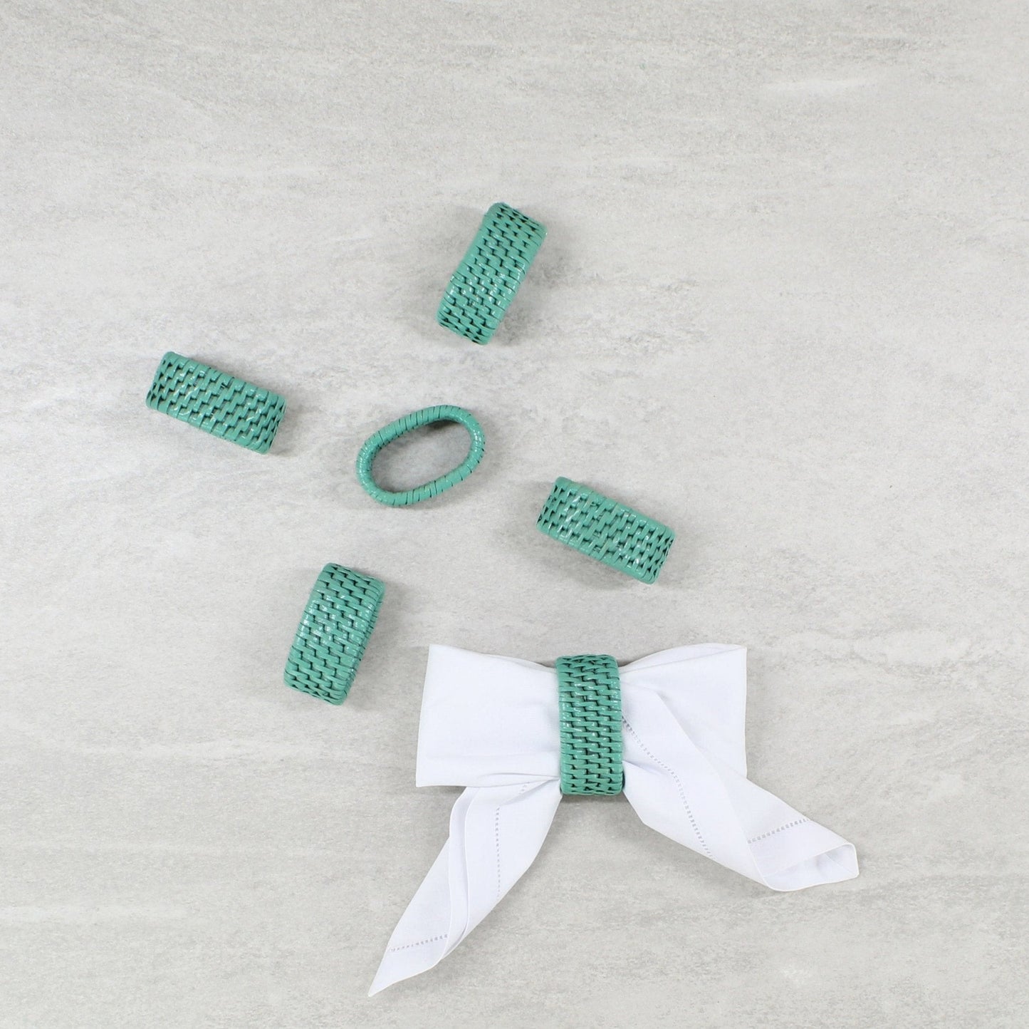 ECO HANDCRAFT turquoise rattan napkin rings set with bow styling, perfect for elegant eco-friendly table decor.