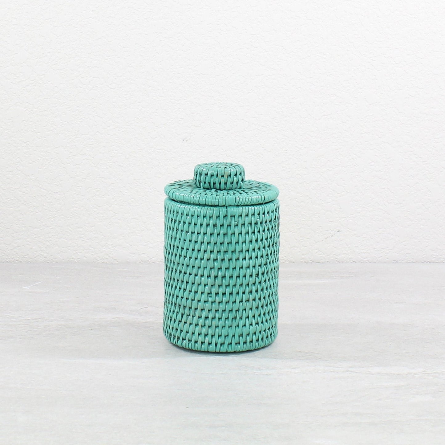 Eco Handcraft turquoise rattan canister with lid for storing small bathroom items, cotton pads, or countertop display