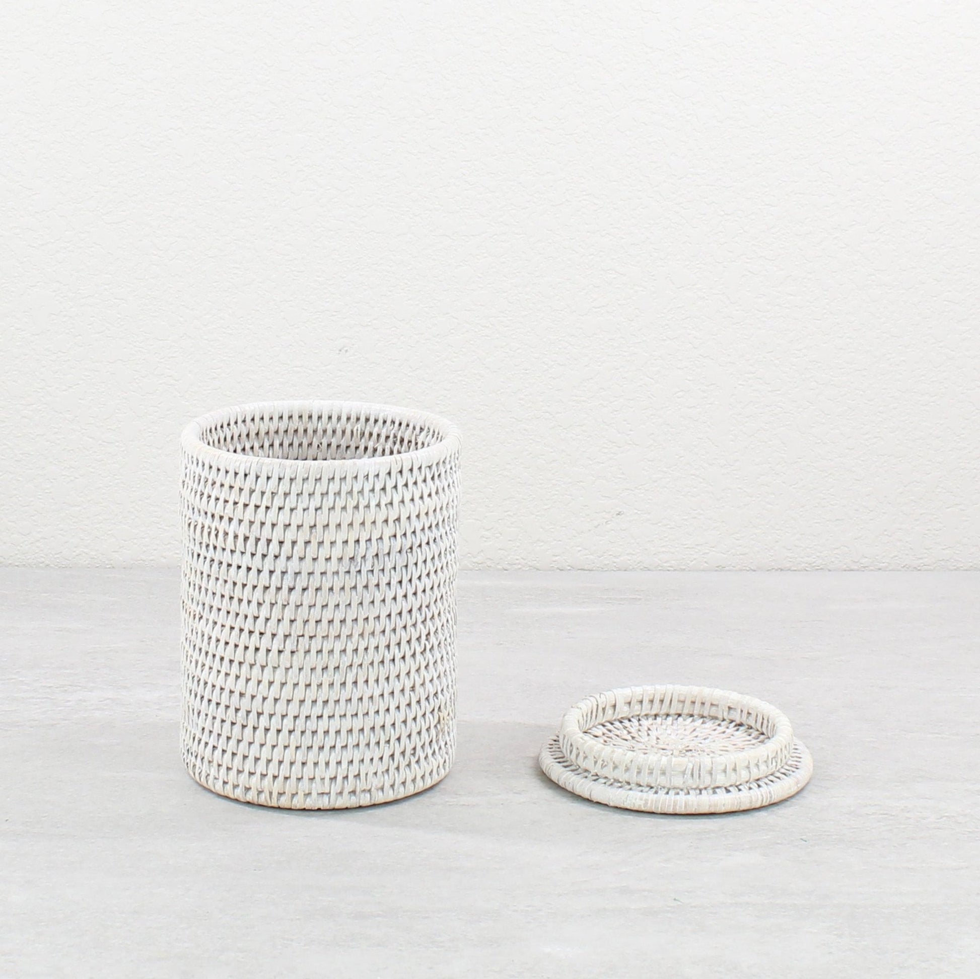 Whitewash rattan canister with removable lid displayed beside it, perfect for elegant eco storage.