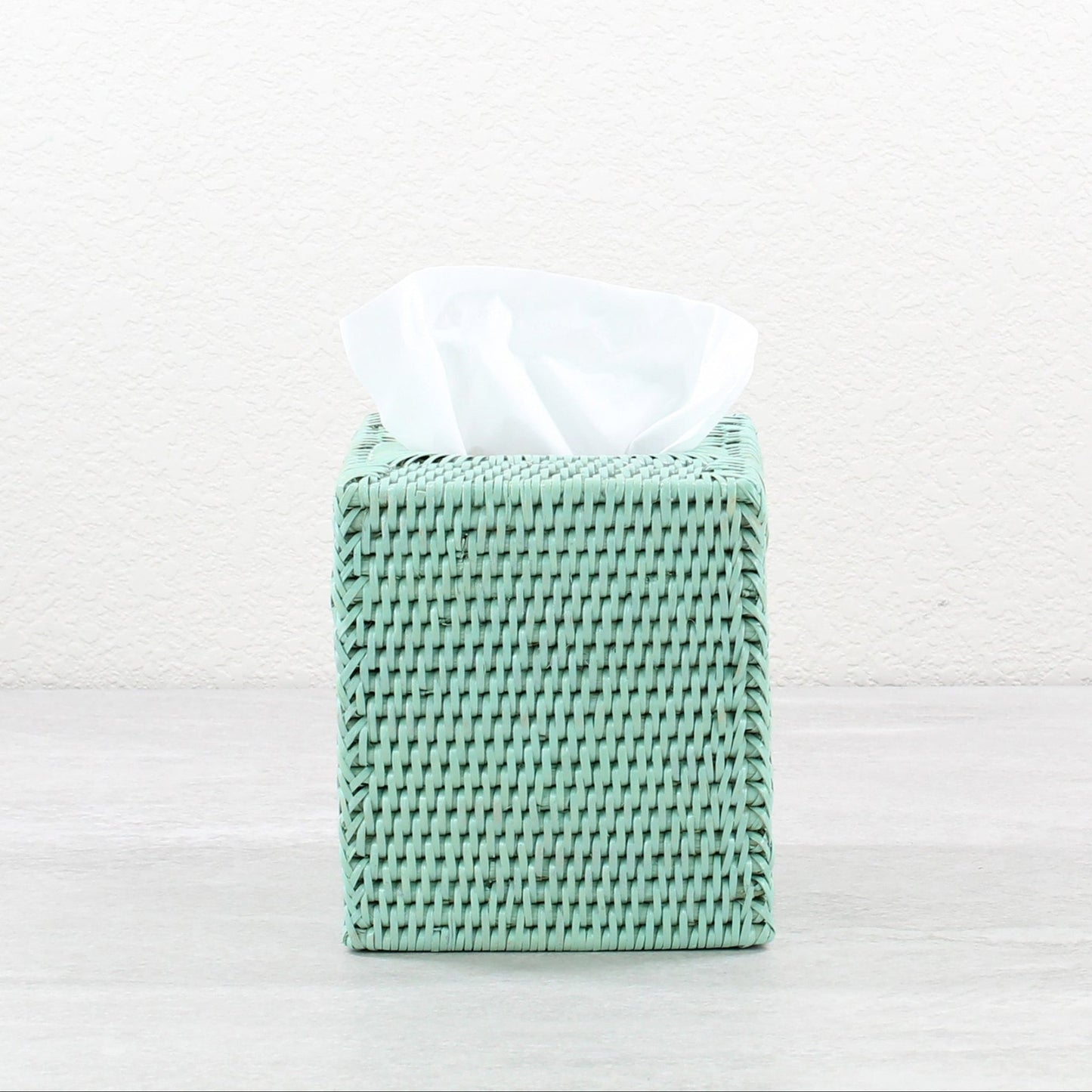 Sage leaf green square rattan tissue box cover displayed on a neutral background.