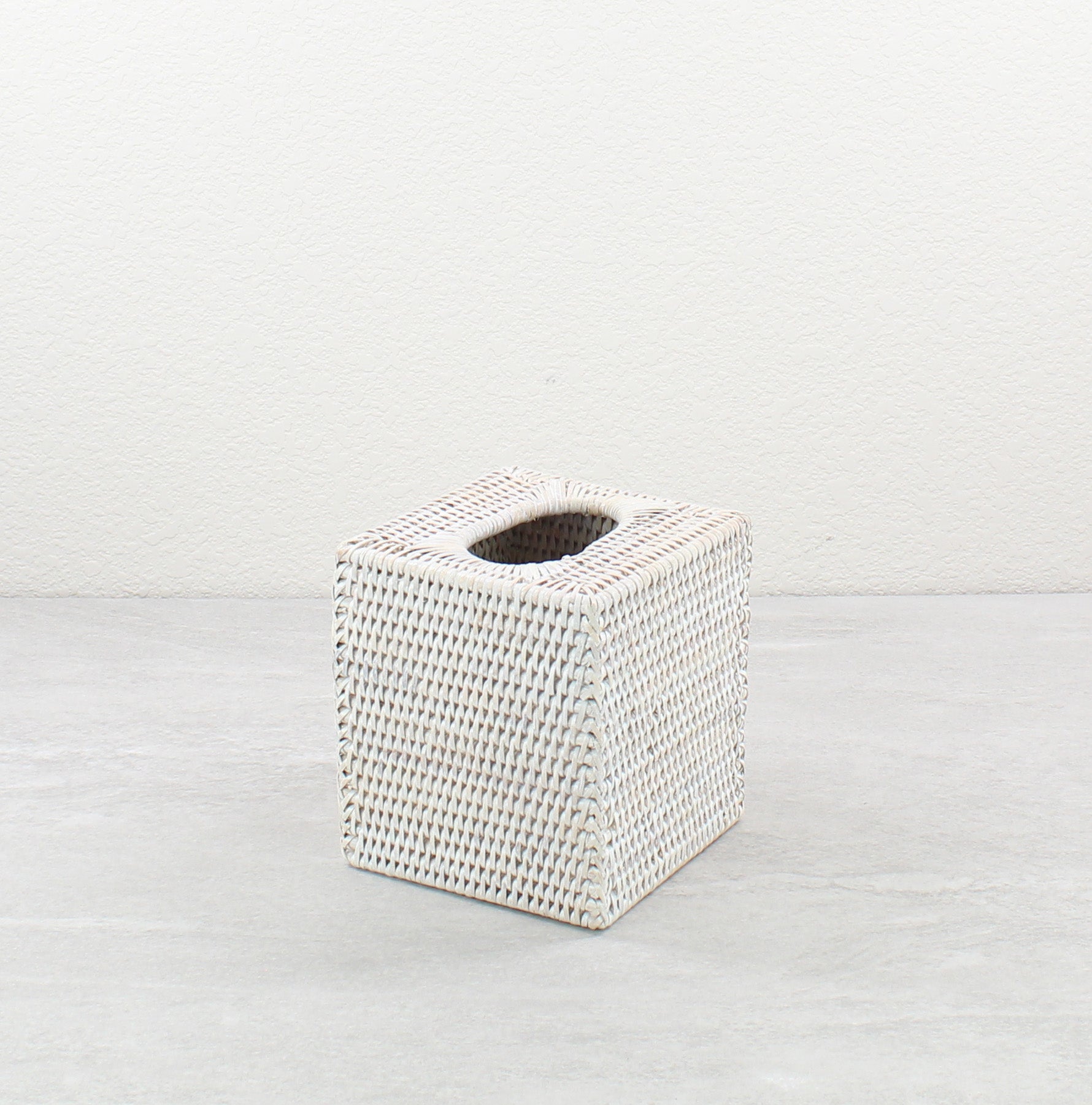 Whitewash square rattan tissue box cover displayed on a neutral background.