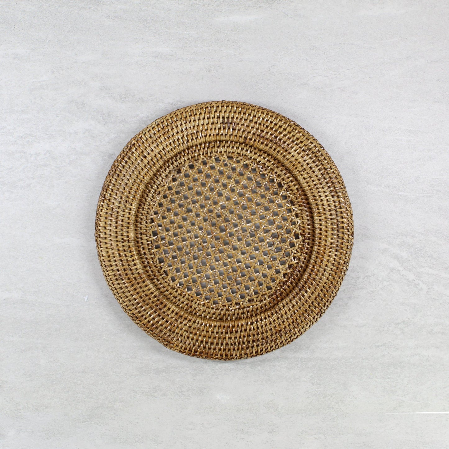 Eco Handcraft round rattan placemat with open-weave center, handwoven for tropical table styling and sustainable home décor.