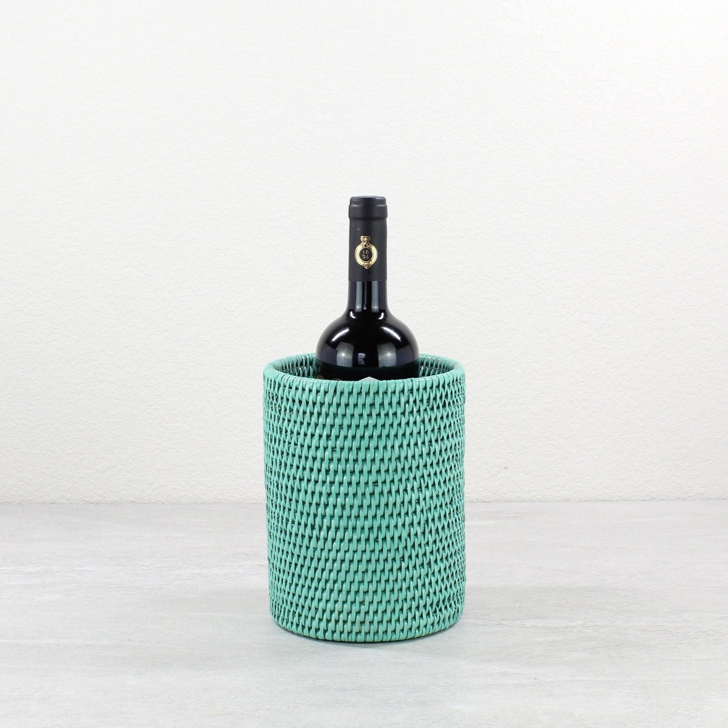 ECO HANDCRAFT turquoise woven rattan wine bottle holder, perfect for elegant, sustainable entertaining.