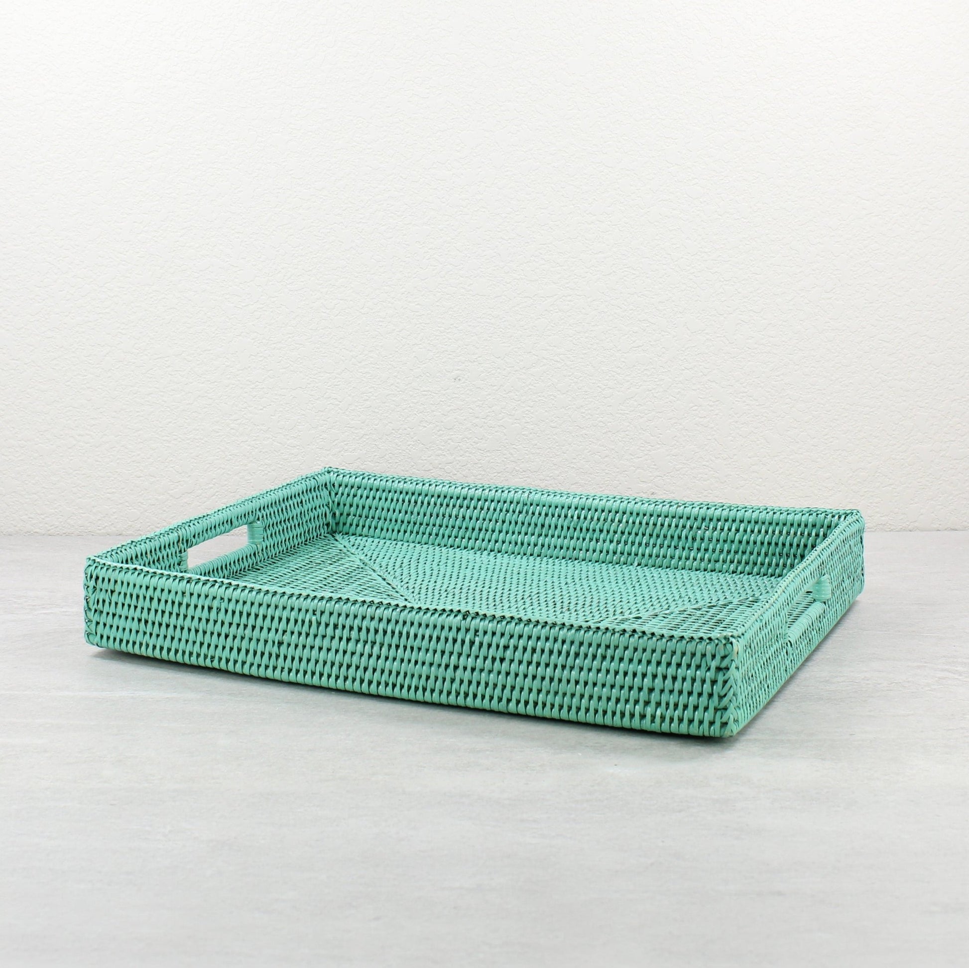 Large sage leaf rattan tray with handles and tight weave, shown on white background for clean product display.