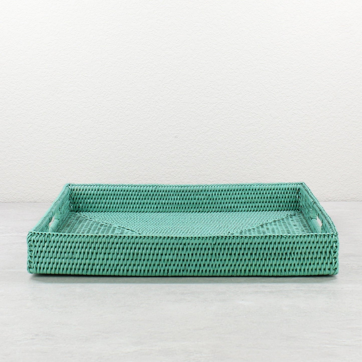 Front view of turquoise rattan tray edge showing detailed tight weave and durable handcrafted construction.