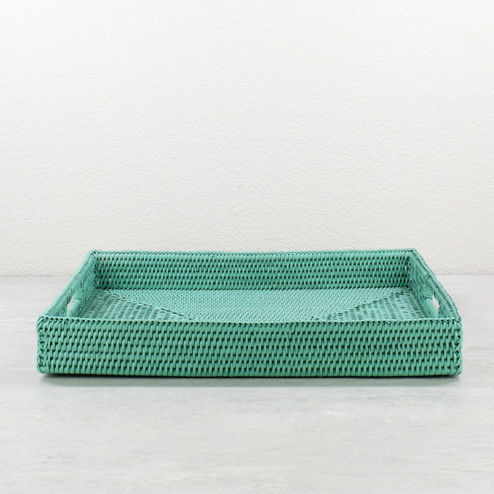 Front view of turquoise rattan tray edge showing detailed tight weave and durable handcrafted construction.
