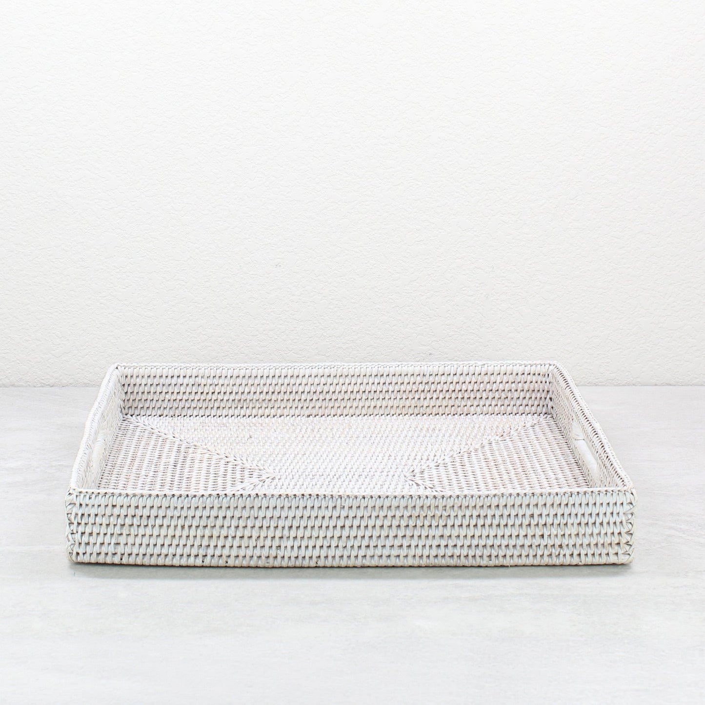 Front view of whitewash rattan tray edge showing detailed tight weave and durable handcrafted construction.