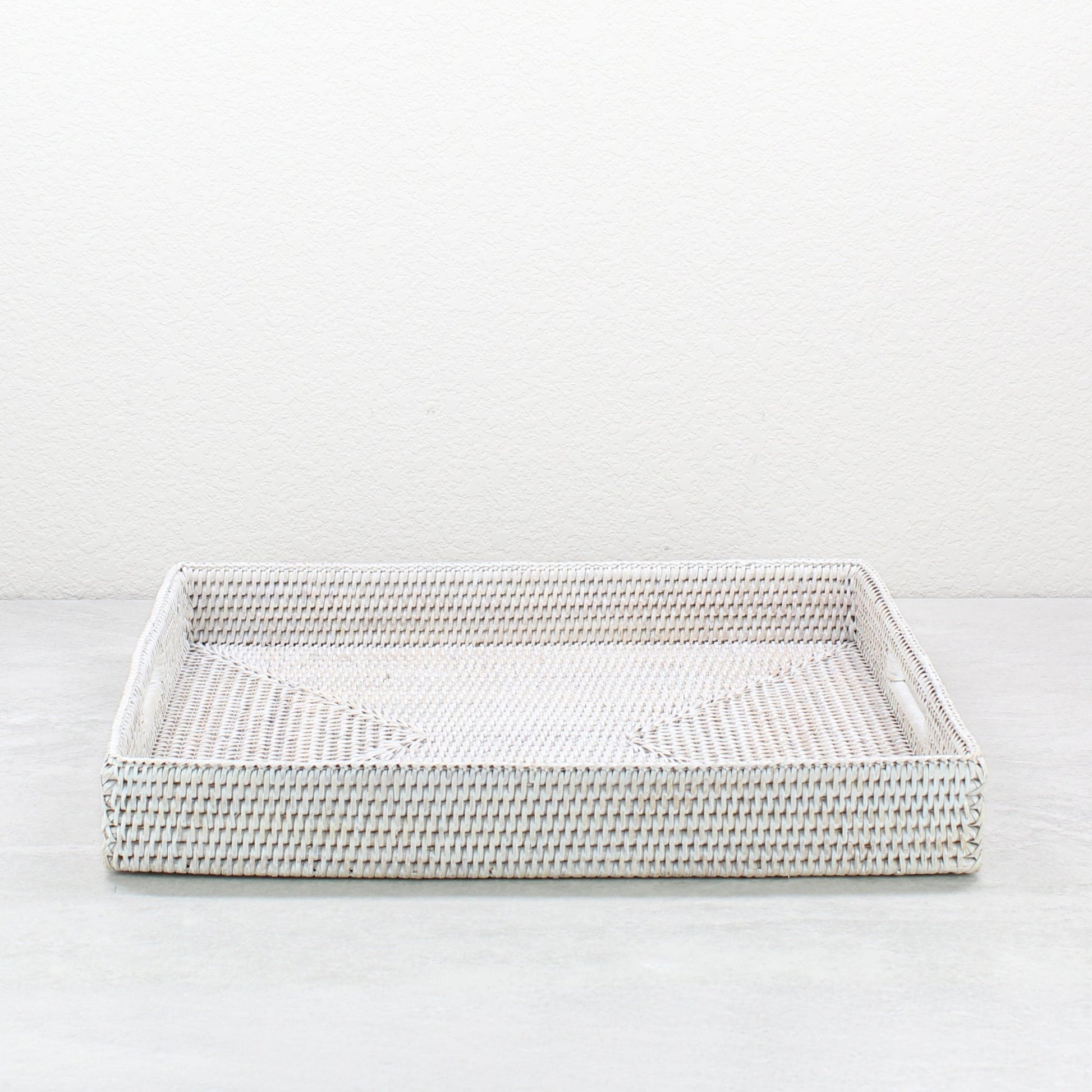 Front view of whitewash rattan tray edge showing detailed tight weave and durable handcrafted construction.