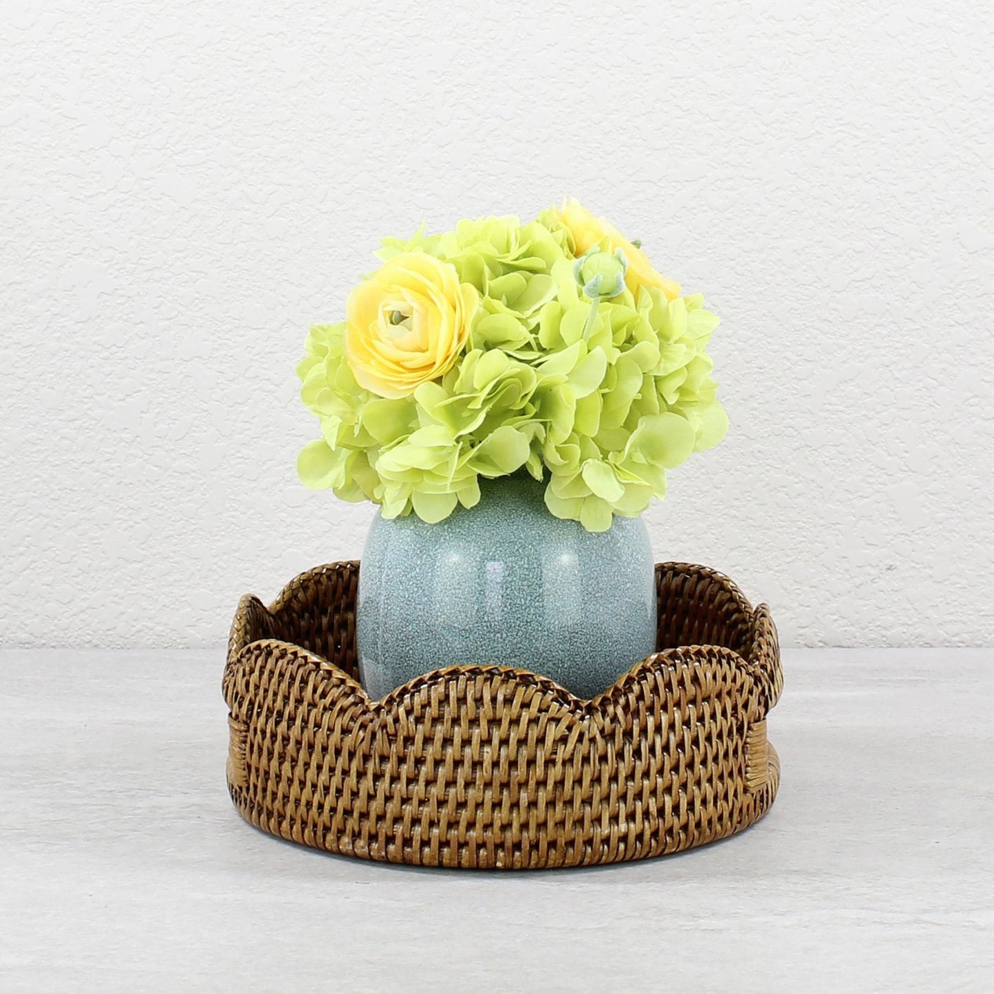 ECO HANDCRAFT scalloped brown rattan bowl with vase and flowers, styled for elegant eco-friendly home décor.