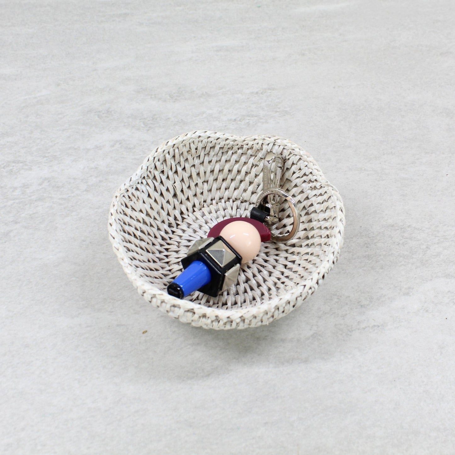 Whitewash mini scalloped rattan catchall tray with tight weave, styled with keychain—perfect for entryway, nightstand, or gift.