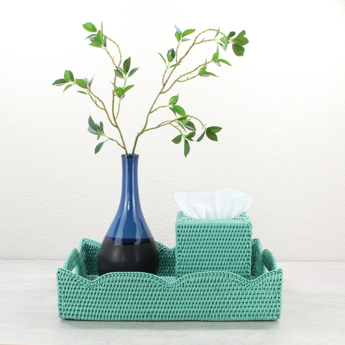 Turquoise medium scalloped rattan tray with tissue box and tall blue vase, styled for bathroom or entryway organization.