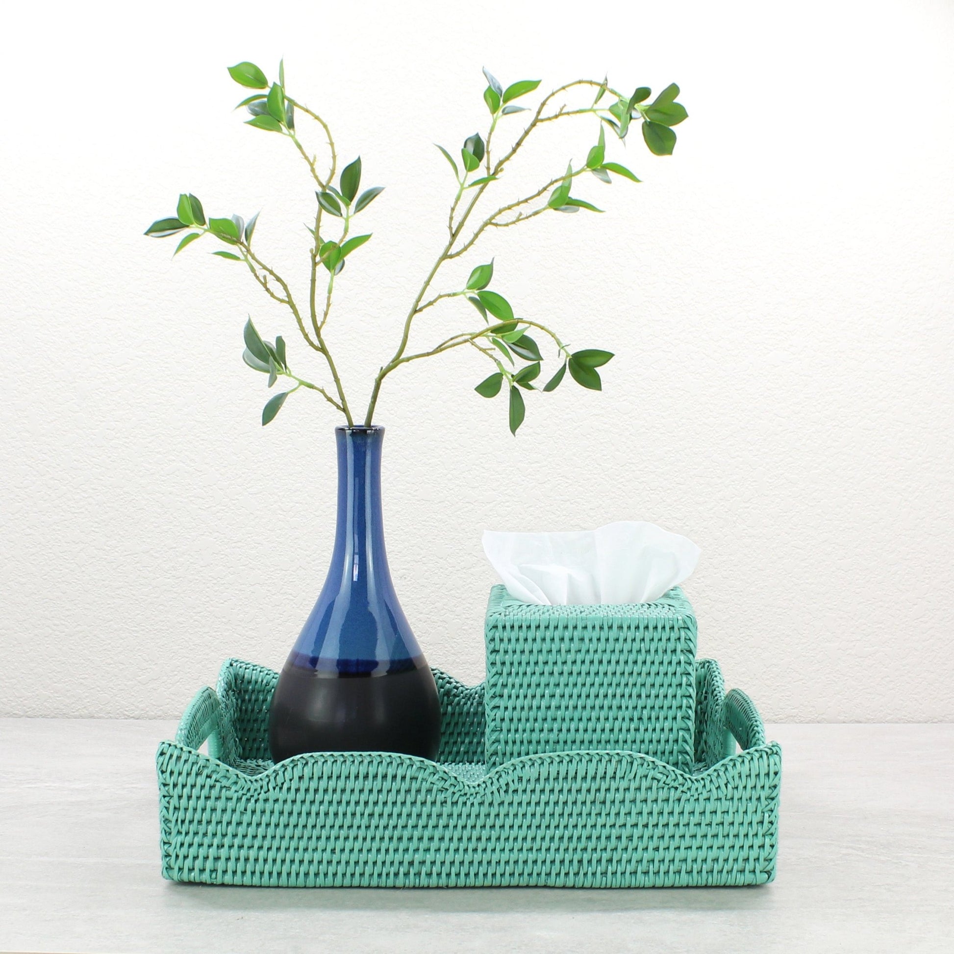 Turquoise medium scalloped rattan tray with tissue box and tall blue vase, styled for bathroom or entryway organization.