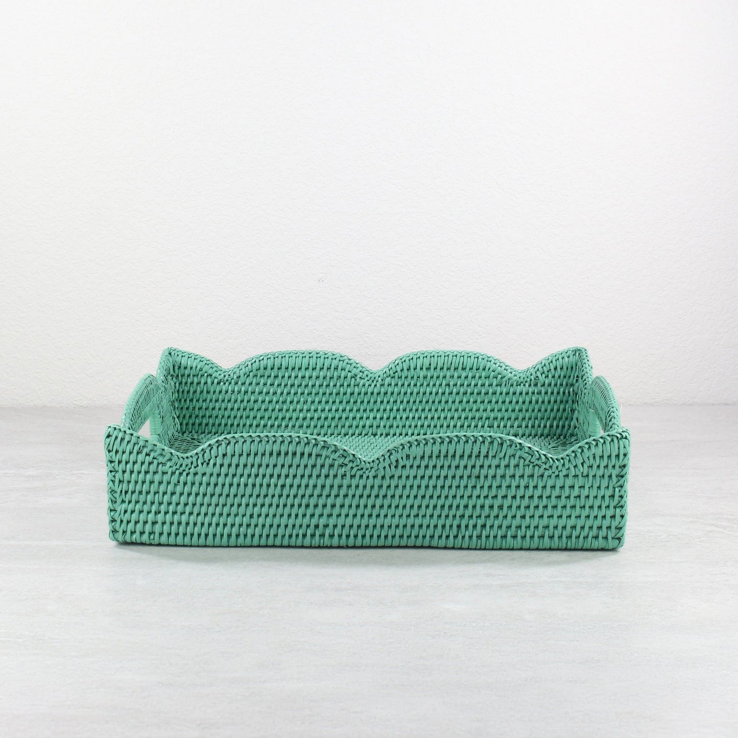Front view of handmade scalloped rattan tray in turquoise, rectangular storage and serving basket crafted from sustainable Burmese rattan.