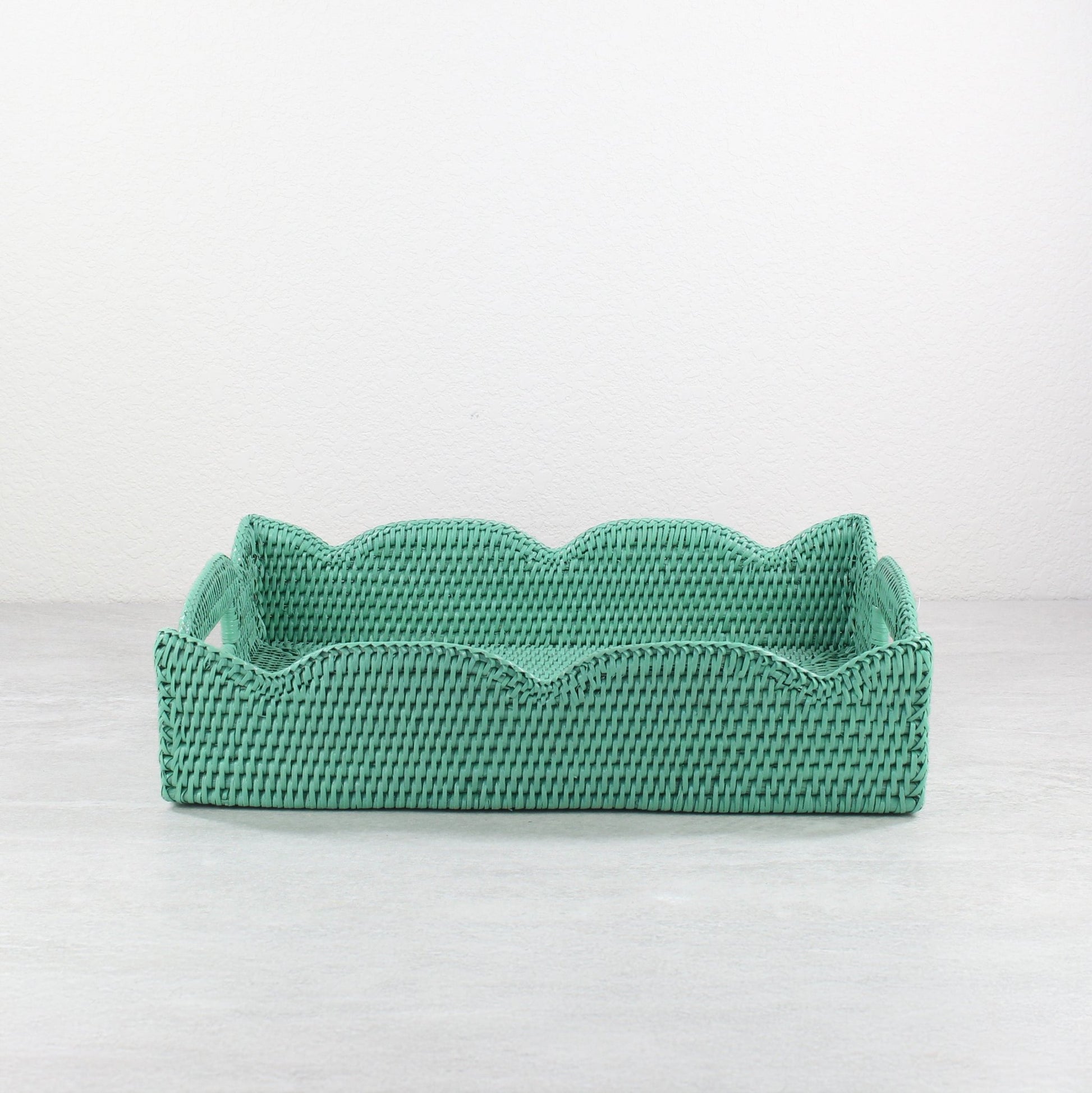 Front view of handmade scalloped rattan tray in turquoise, rectangular storage and serving basket crafted from sustainable Burmese rattan.