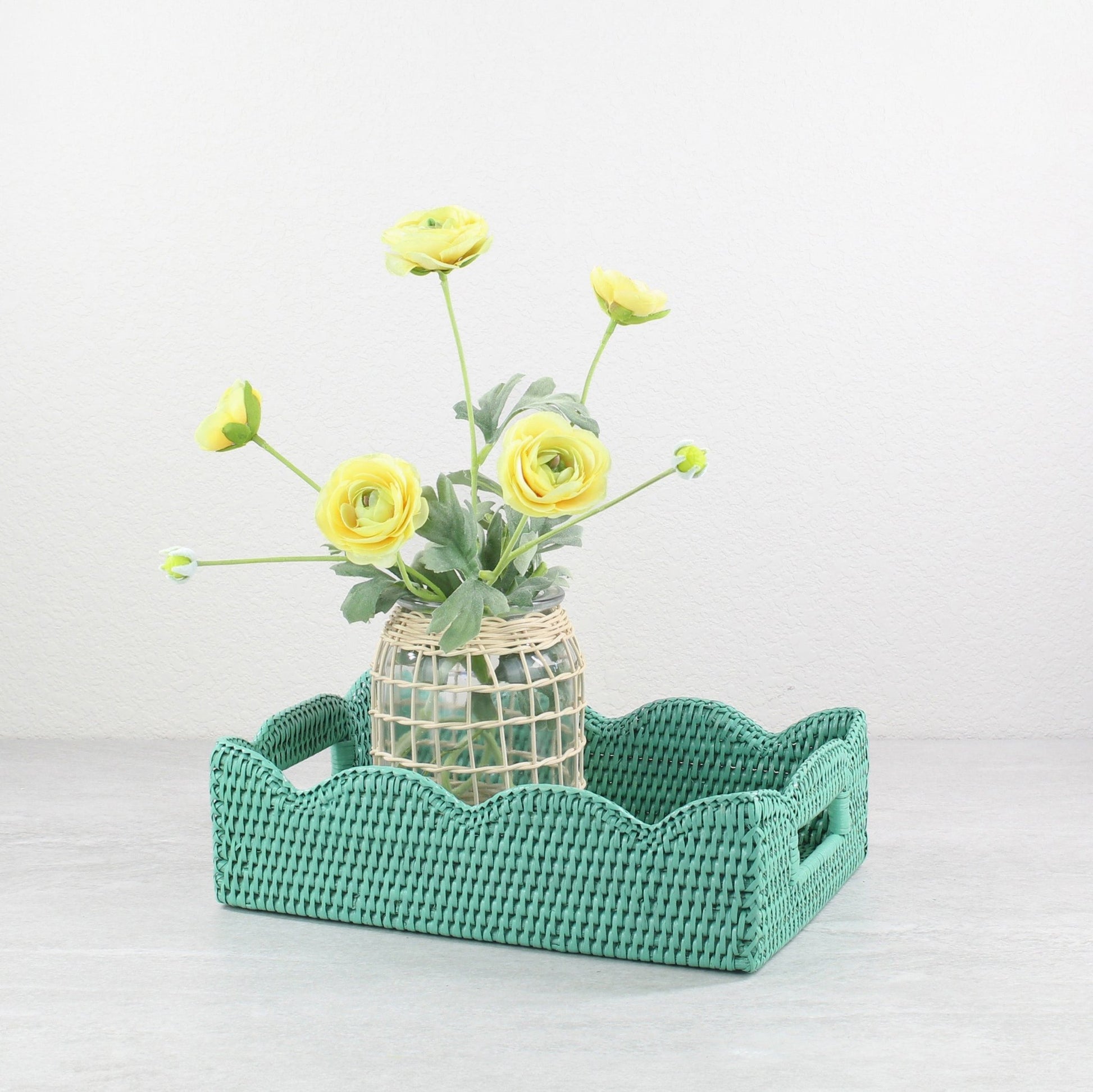 Decorative small turquoise scalloped rattan tray styled with yellow flower vase, sustainable handmade home décor accent for coffee tables or dining.