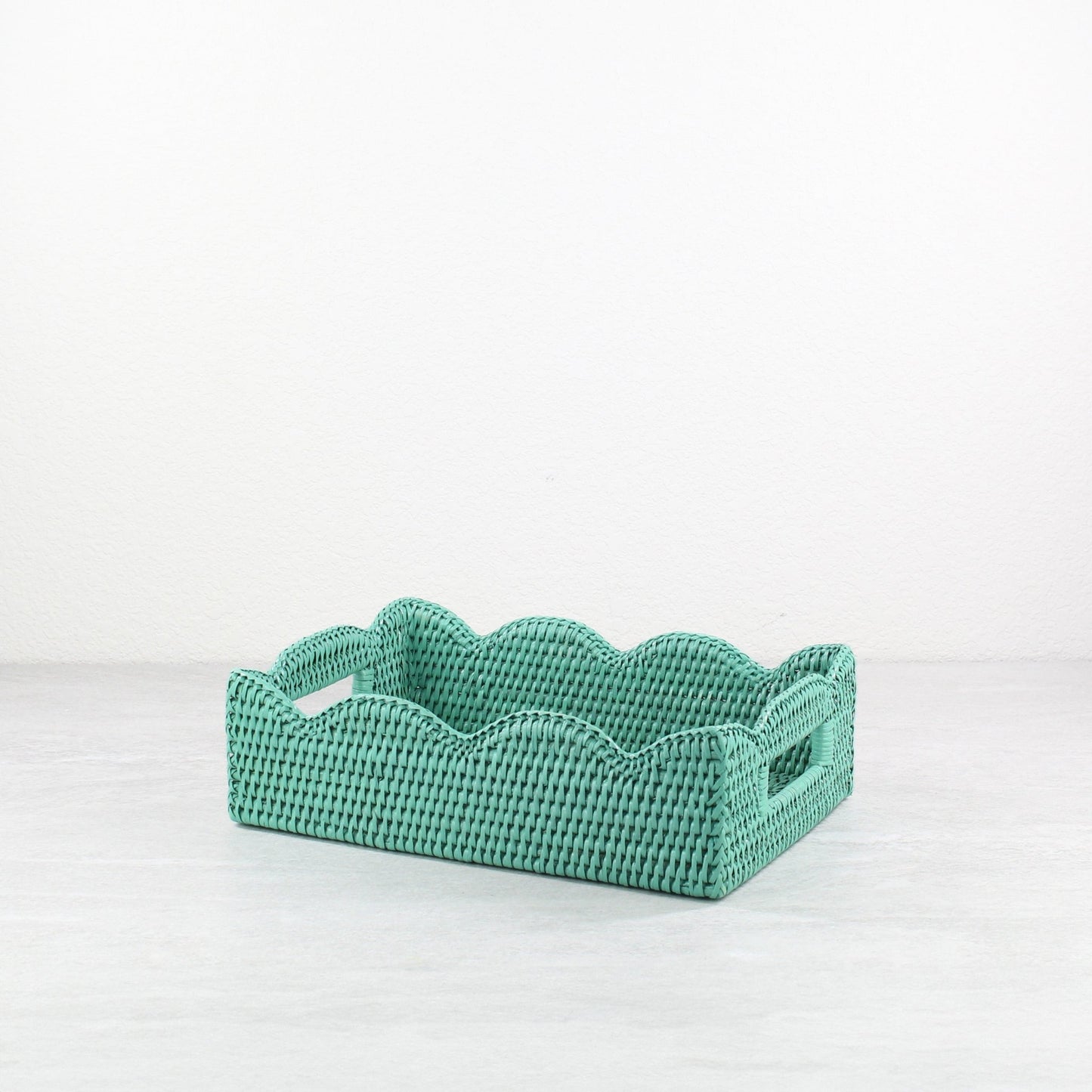 Small handwoven scalloped rectangle rattan tray in turquoise, eco-friendly storage and serving tray with decorative wavy edges.