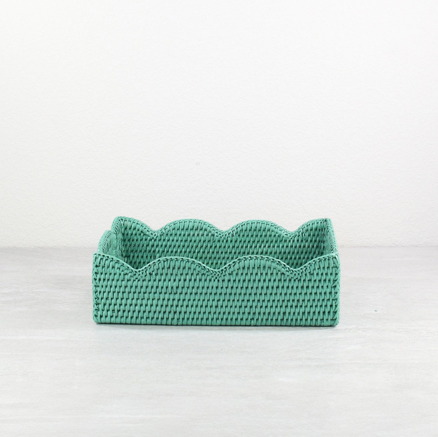 Front view of turquoise scalloped edge rattan tray, rectangular eco-friendly handmade tray with wavy decorative border.
