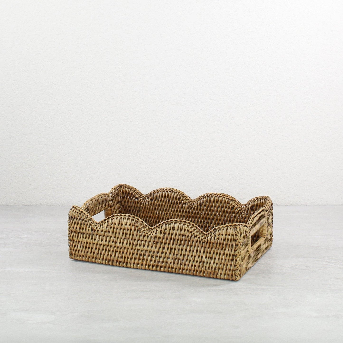 ECO HANDCRAFT small scalloped brown rattan tray with handles, handmade for elegant serving or decorative storage.
