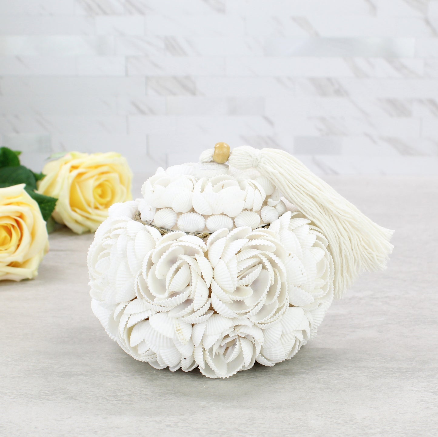 Large artisan-crafted seashell rose storage box with tassel and wood accent, handmade from natural shells for coastal-inspired decorative storage.
