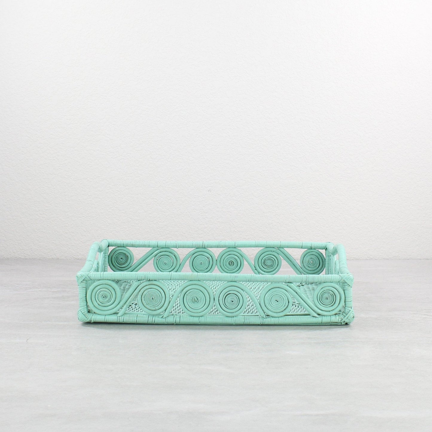 Small swirly rectangle rattan tray in sage leaf green, tight-woven with handles, shown on white background for product display
