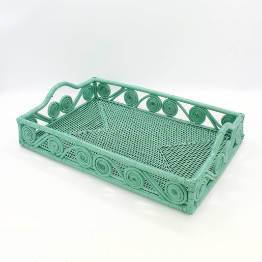 Empty turquoise rectangle rattan tray with swirl design and raised handles, handmade for serving or home décor.