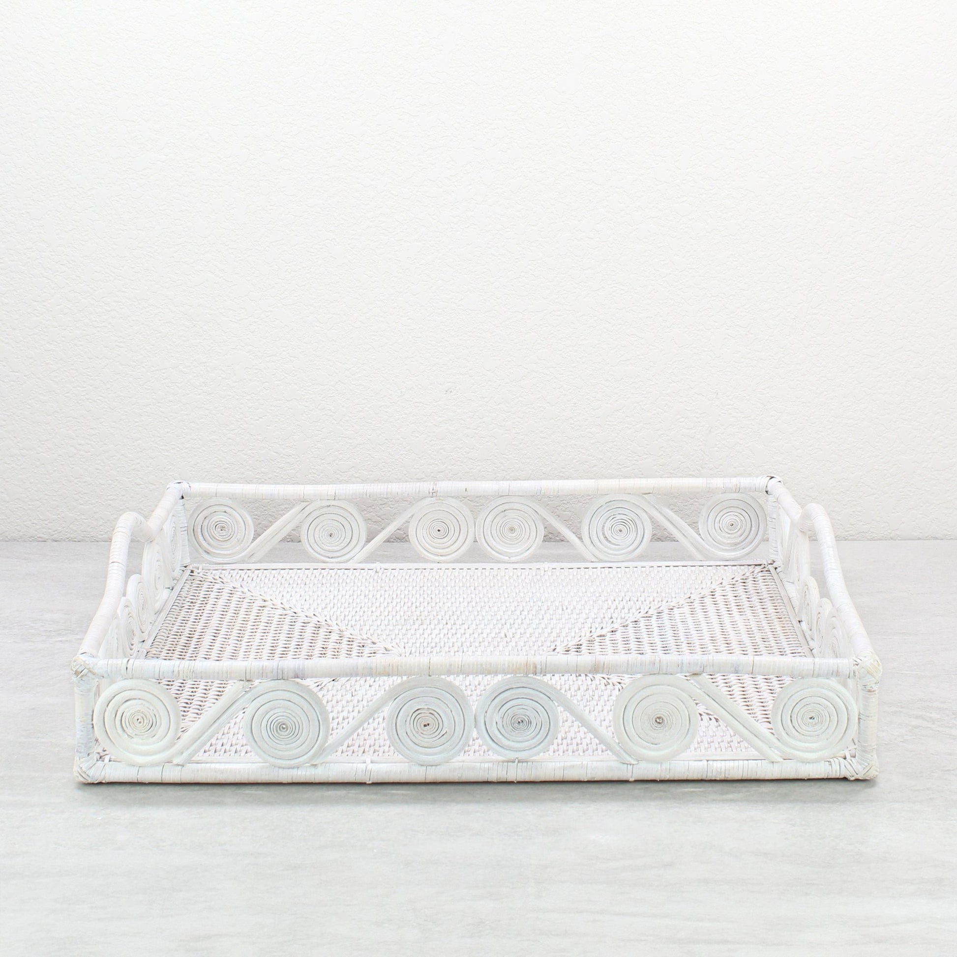 Whitewash rectangular rattan tray with swirl edge design, handmade for serving, organizing, or modern home décor styling, front view.