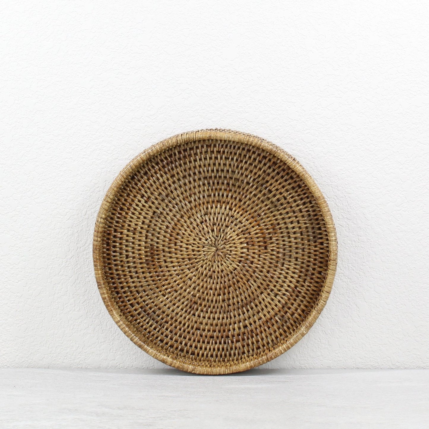ECO HANDCRAFT round brown rattan tray, handcrafted for eco-conscious serving, organizing, or decorative wall use.