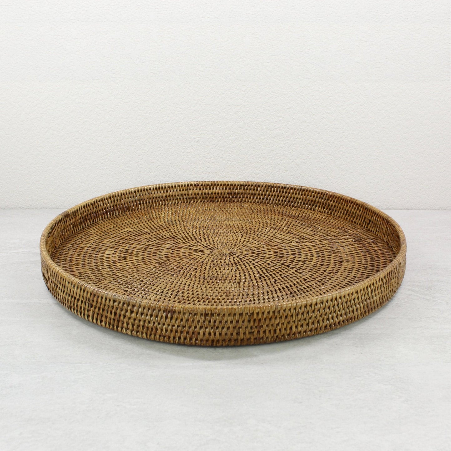 Eco Handcraft large round honey brown rattan tray with raised edge and spiral weave, ideal for serving or organizing at home