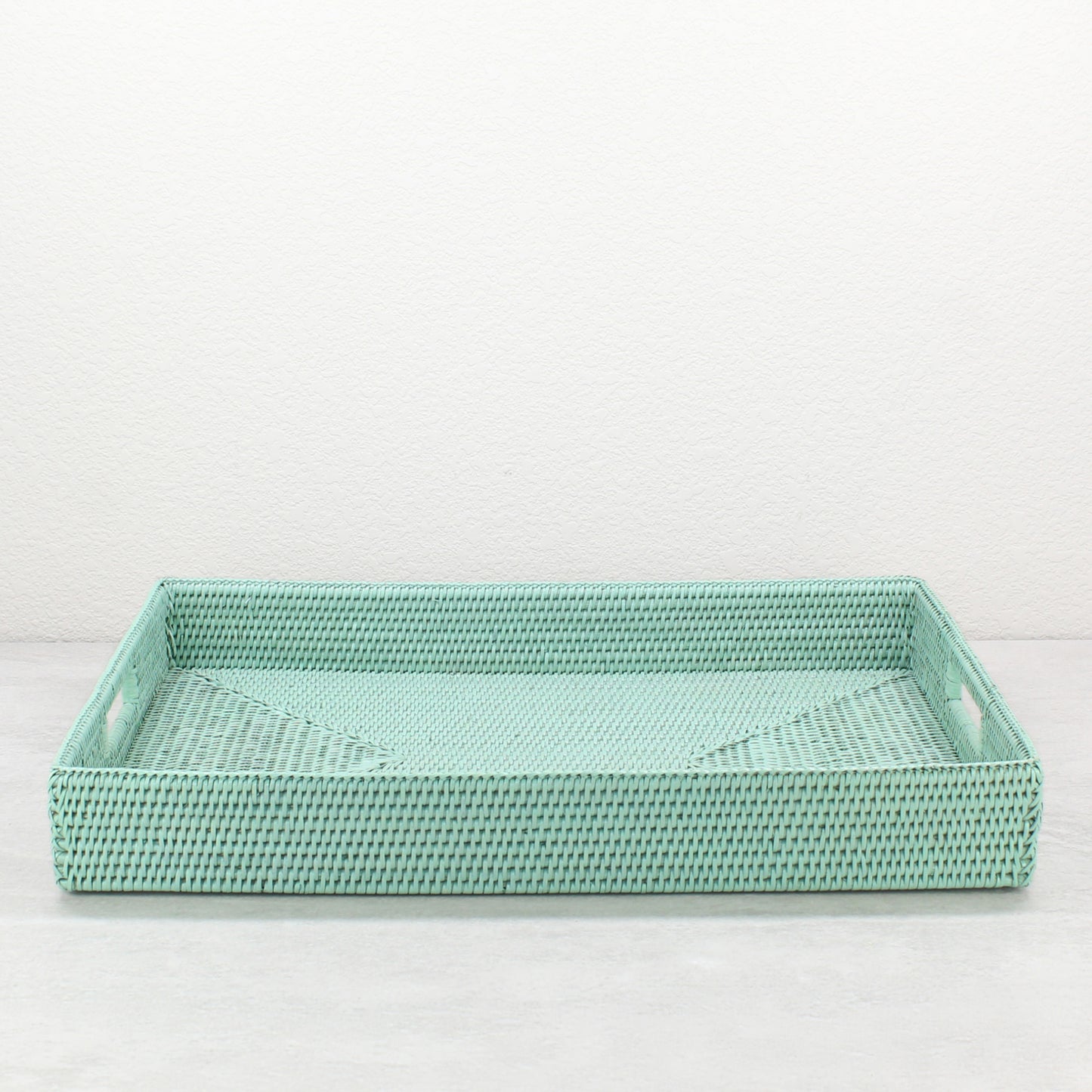 Handwoven sage leaf rattan storage tray with handles, shown in extra-large size for versatile dining, entertaining, or organizing