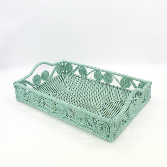 Empty sage leaf green rectangle rattan tray with swirl design and raised handles, handmade for serving or home décor.