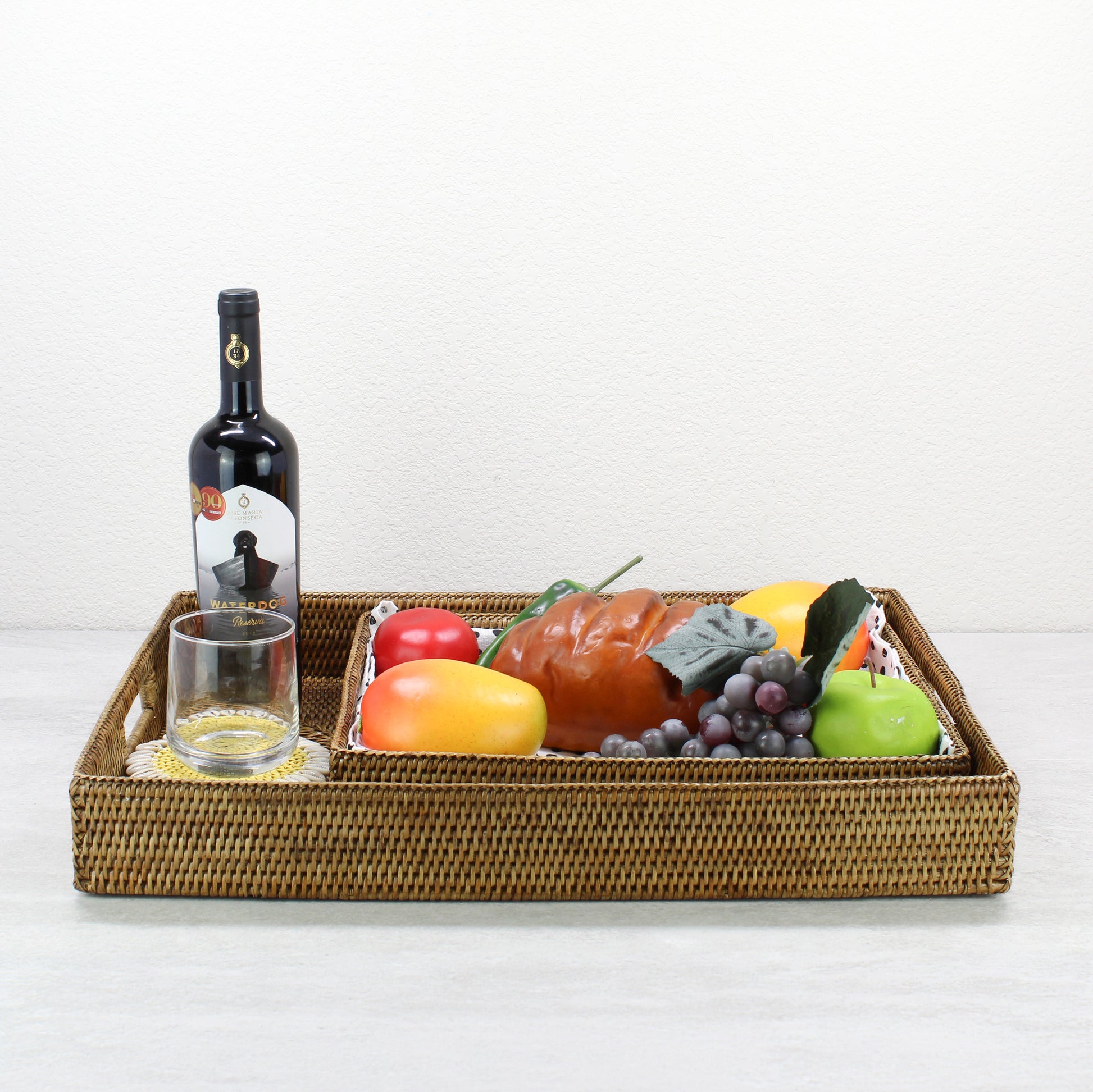 Eco Handcraft honey brown rattan serving tray styled with fruit, wine, and glassware for kitchen, dining, or entertaining décor