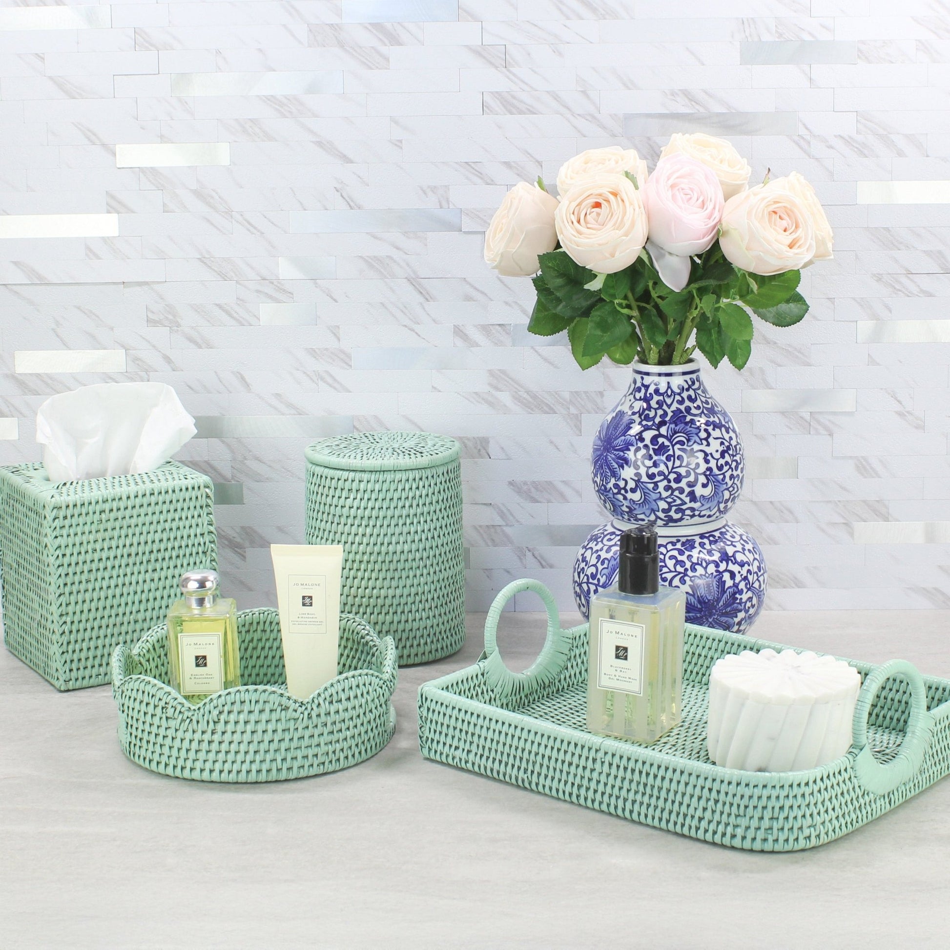 Eco Handcraft sage green rattan vanity set with round and oval trays – handmade spa decor styled with blue vase and roses