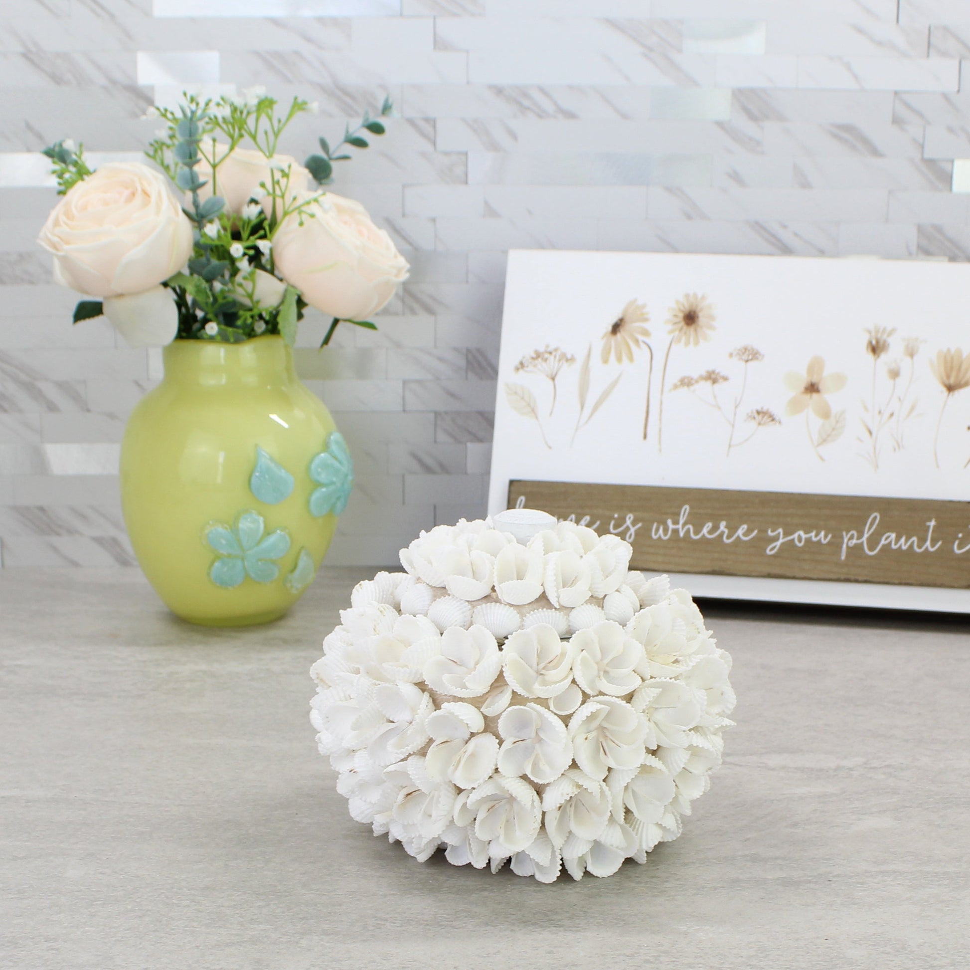 Small artisan-crafted seashell blossom box with lid, designed from natural white shells to resemble flowers, beach-inspired decorative storage.
