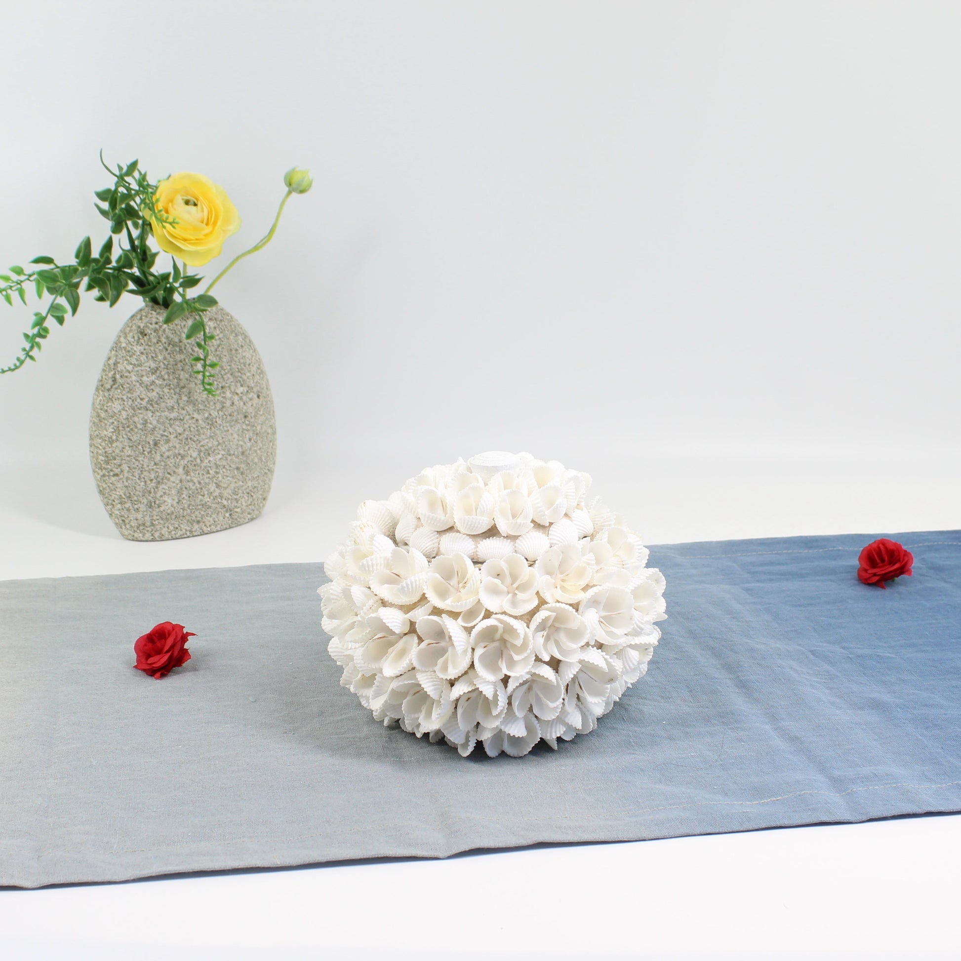 Large handmade seashell blossom decorative storage box with floral shell design, styled with a yellow flower vase and red rose accents for coastal décor.