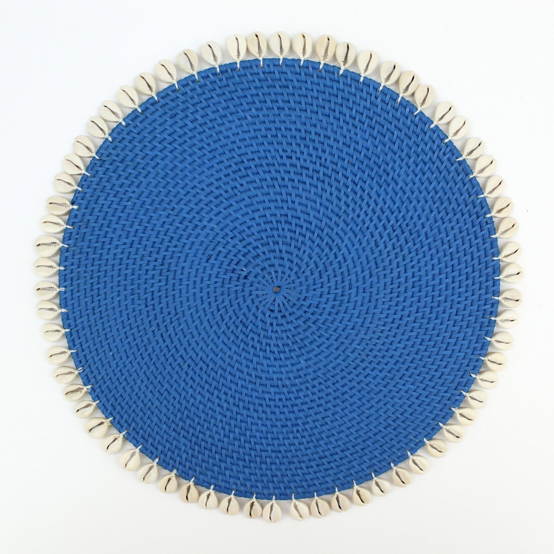 Round blue rattan placemat with natural shell trim, handmade for coastal-style dining and eco-friendly homes