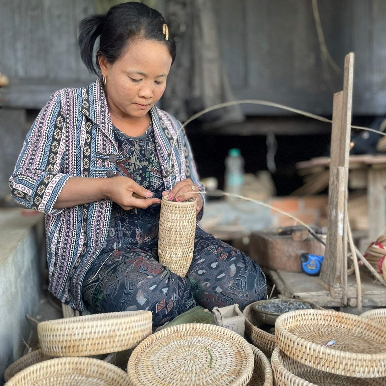 Eco Handcraft artisan weaving rattan by hand in natural daylight, showcasing slow and sustainable craftsmanship