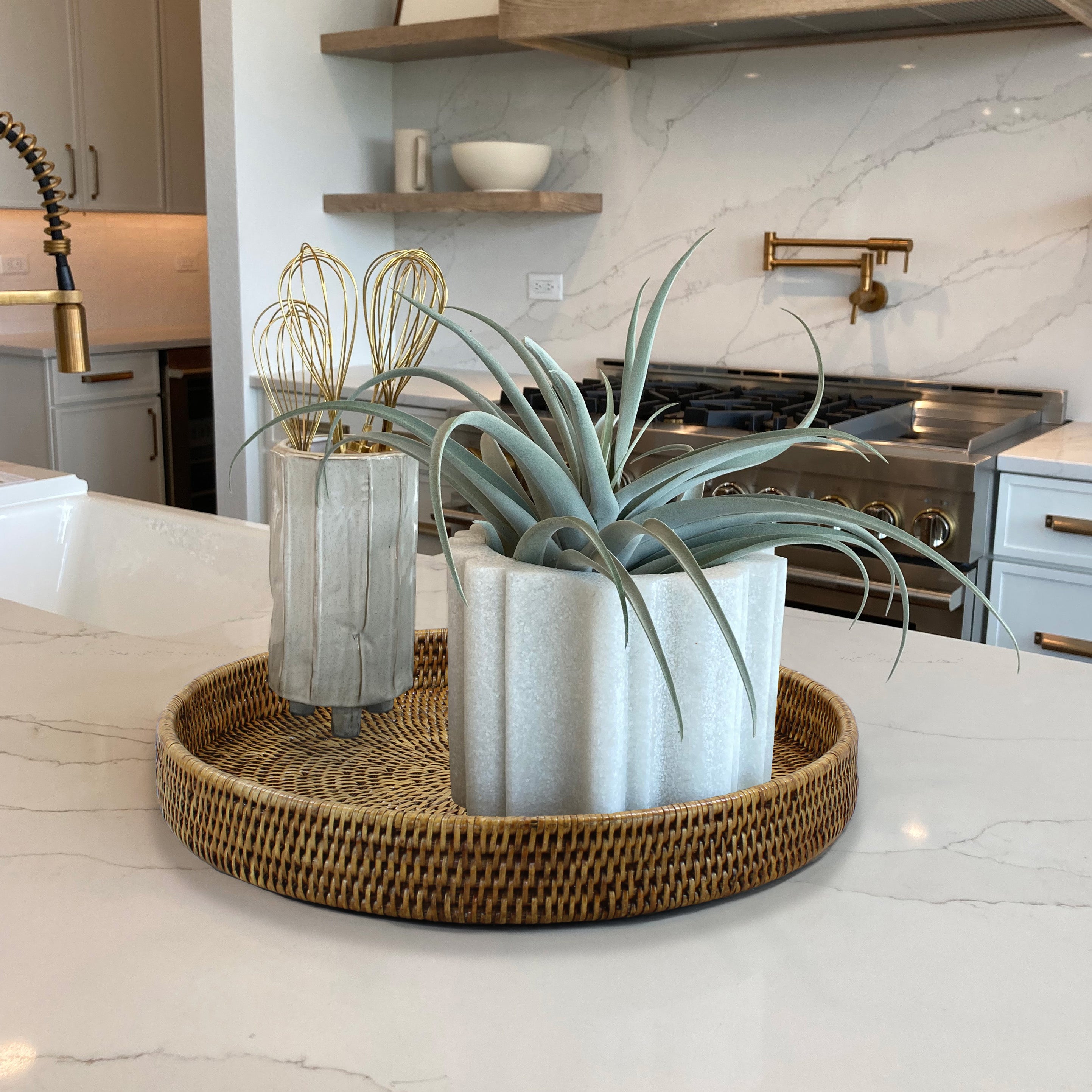 Eco Handcraft round rattan tray styled on a modern kitchen island with planters, ideal for sustainable home organization