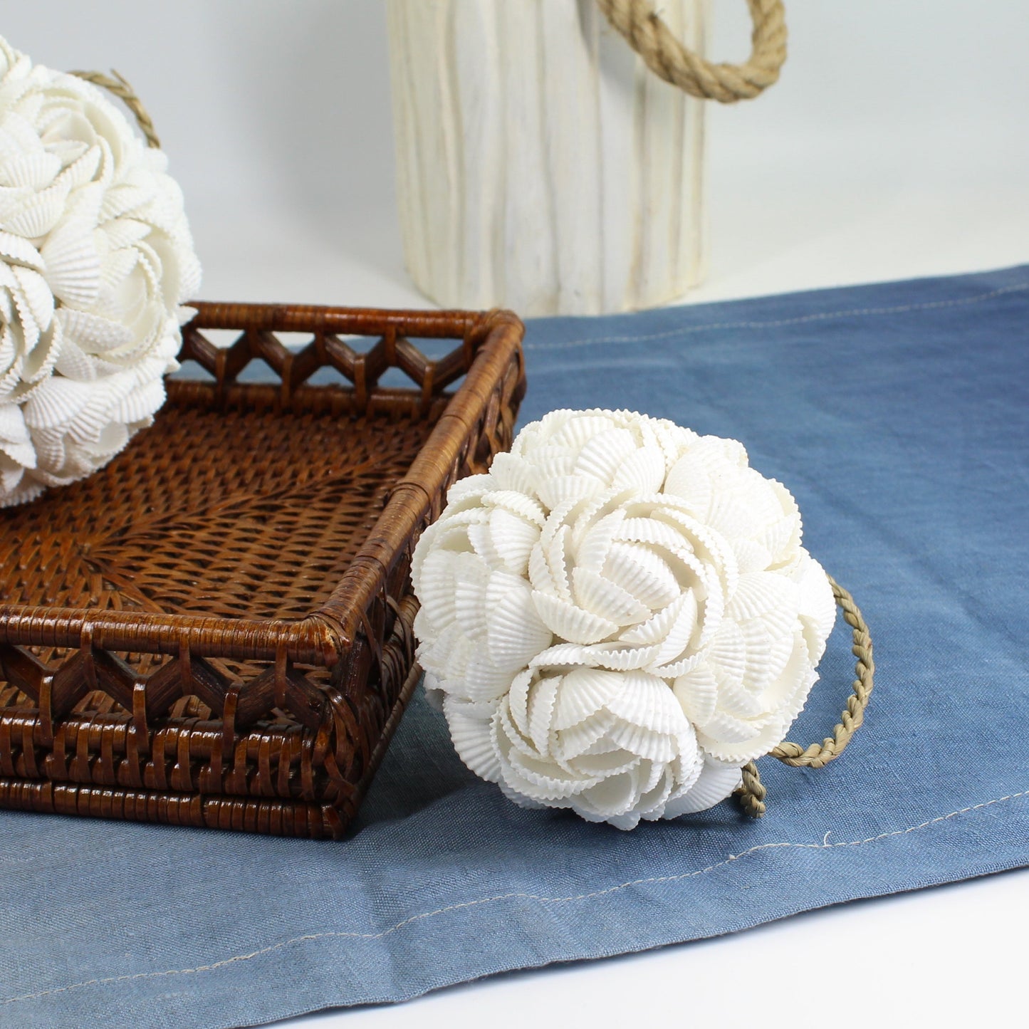 Small seashell rose ball ornament with rope loop handcrafted from natural white shells, designed for coastal tray styling or decorative bowls.
