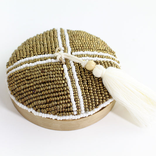 Close-up of handmade white and gold grid pattern beaded bamboo tassel box showing detailed beadwork and natural bamboo texture.