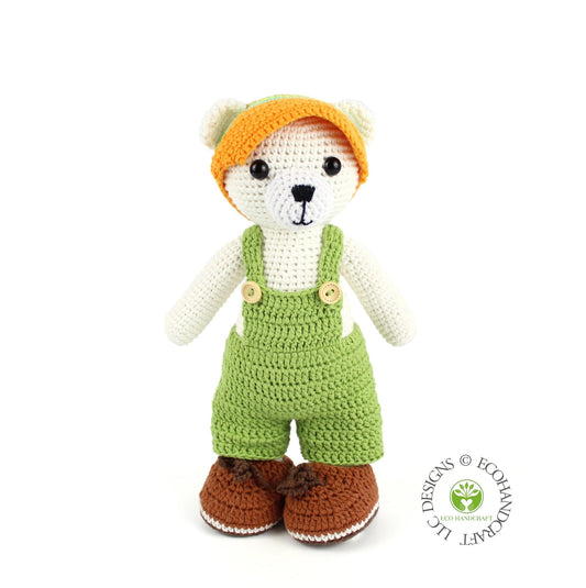 Handmade crochet polar bear doll in green overalls and orange hat, sustainable amigurumi Christmas gift.