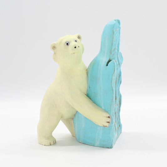 Front view of Eco Handcraft polar bear wood sculpture hugging ice block, hand-painted artisanal holiday décor.