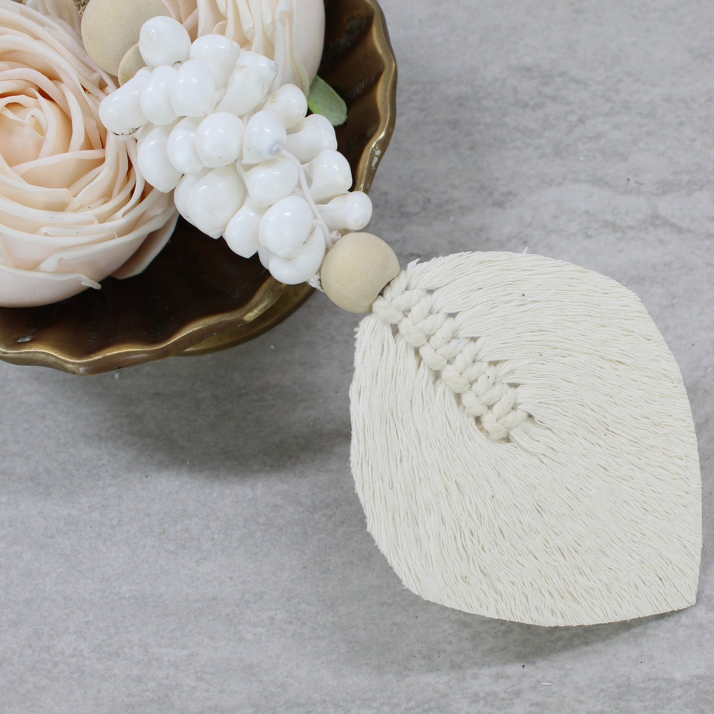 Handcrafted coastal-style white shell tassel tieback by Eco Handcraft featuring braided jute hanger and cotton fringe leaf