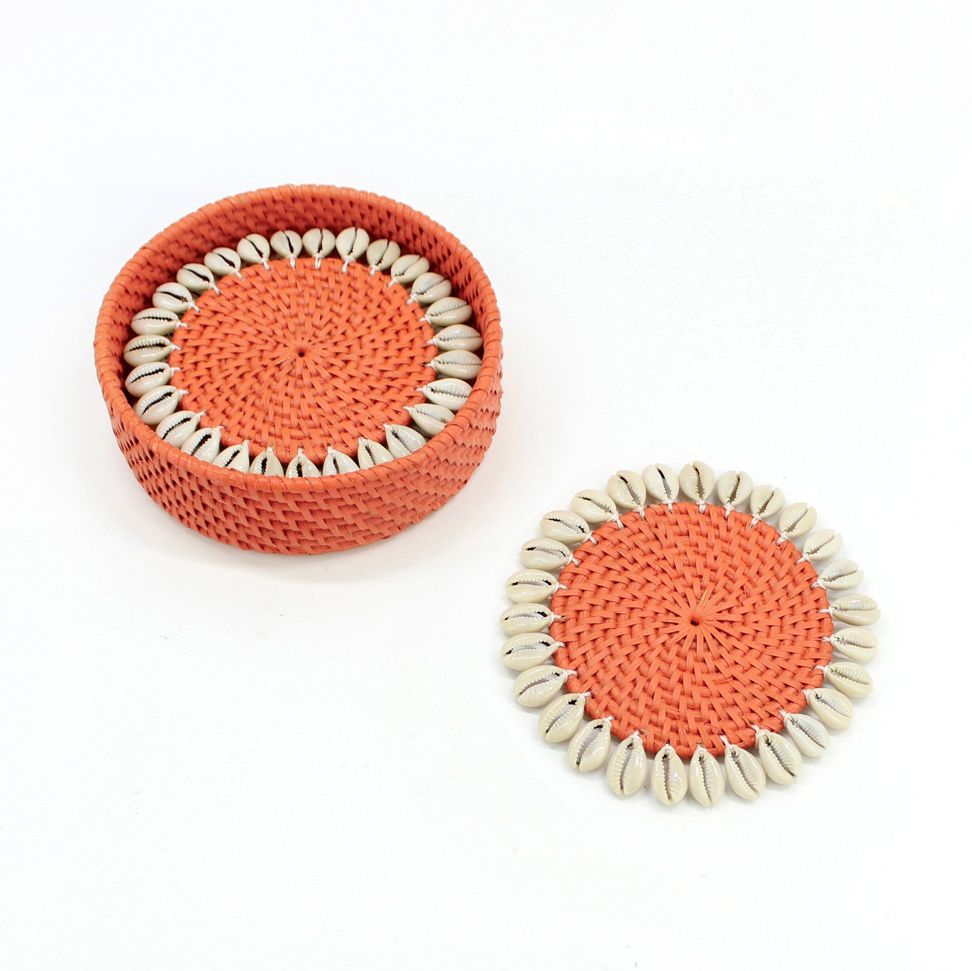 Set of orange rattan coasters with natural seashell trim and matching holder, artisan handmade eco-friendly tableware