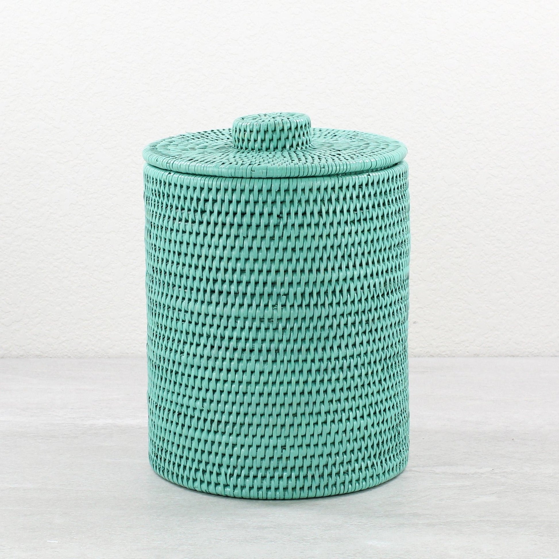 Turquoise round rattan waste bin with lid, tightly woven and handmade, shown on white background for product display.