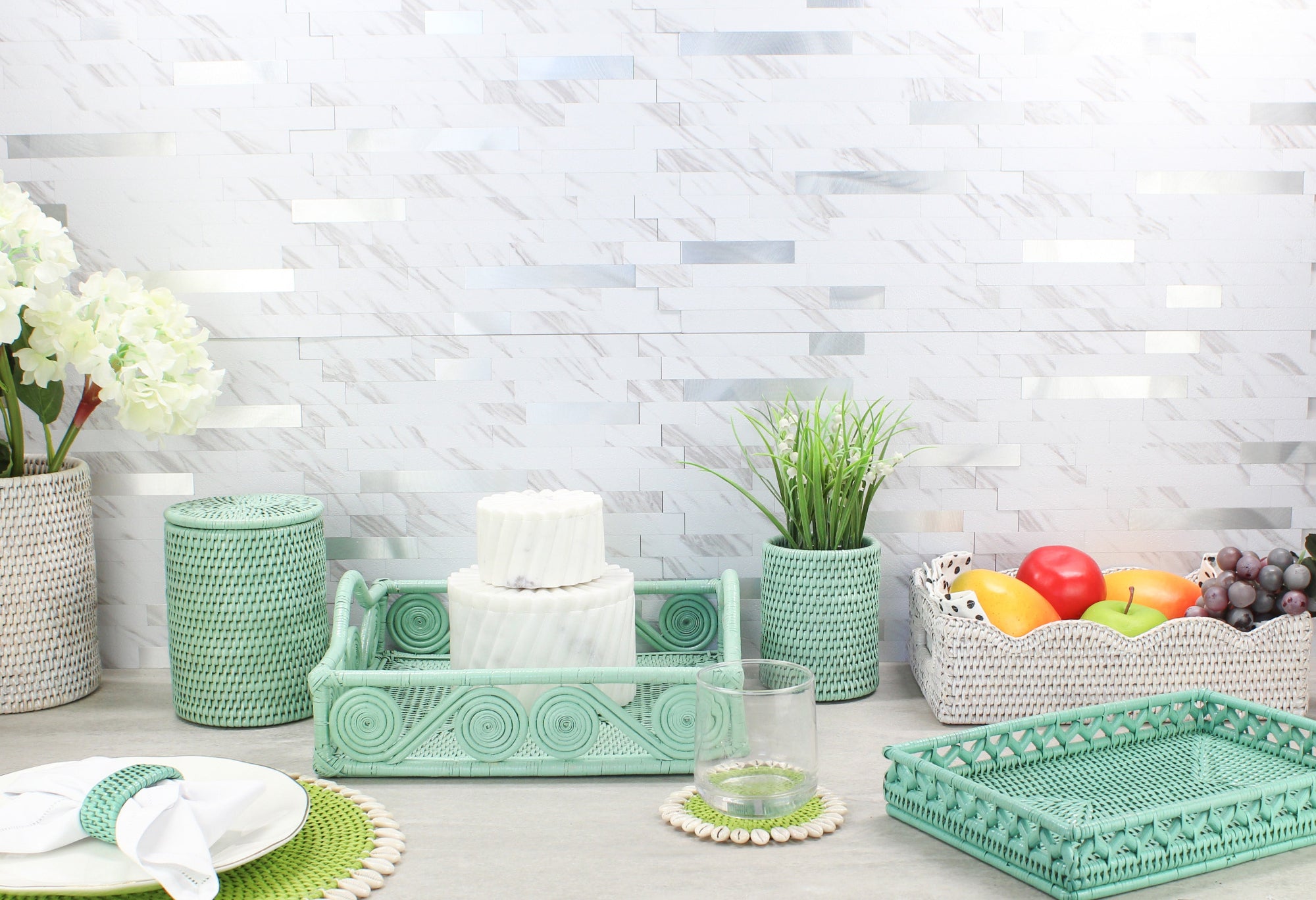 Eco Handcraft's assorted rattan trays in scalloped, swirly, and rectangular shapes styled with table and shelf accessories