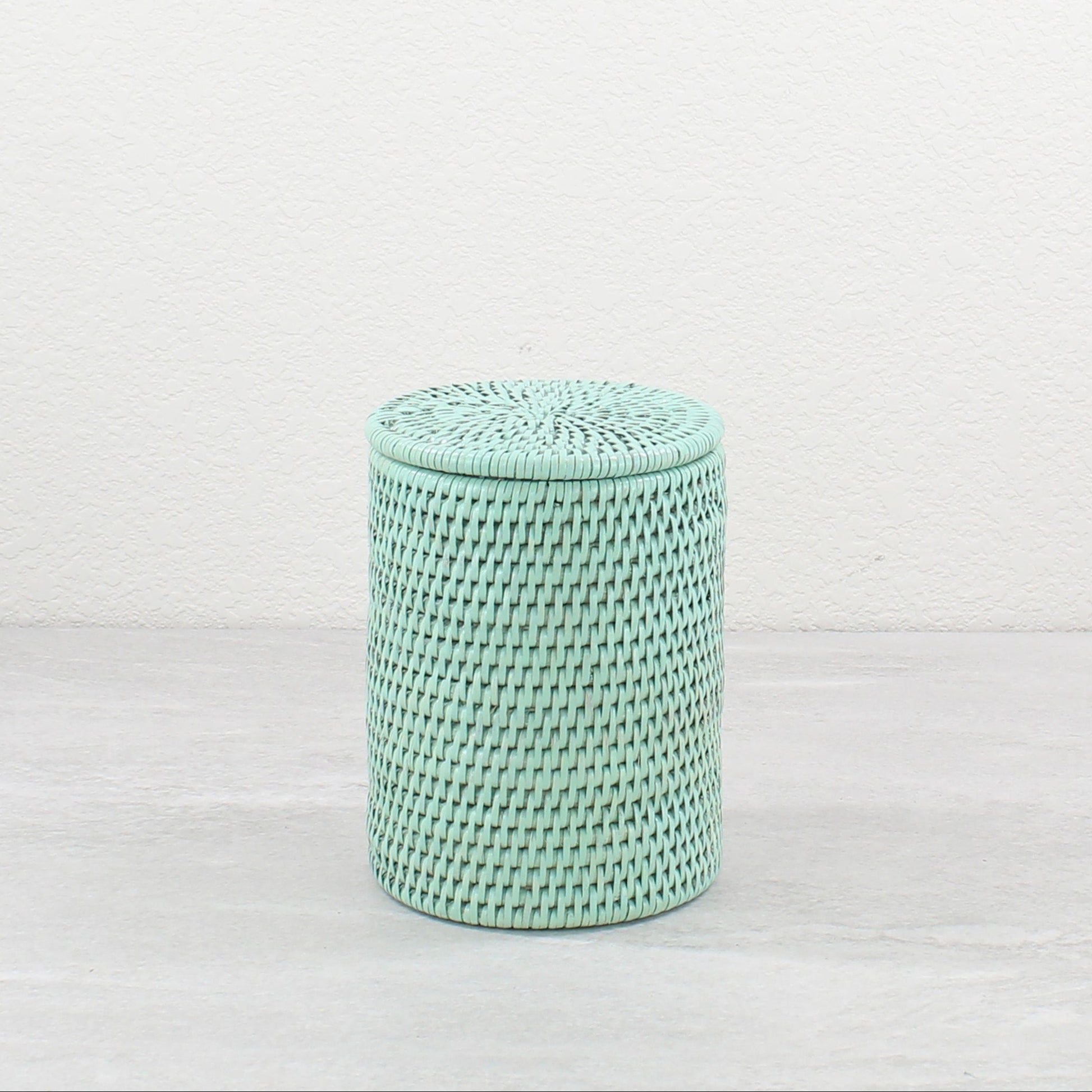 Sage leaf green rattan canister with lid on, eco-friendly storage for bathroom or kitchen countertops