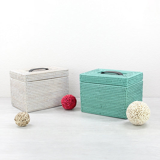 White and turquoise handwoven rattan make up boxes with decorative bead garlands, displayed on a light gray background.