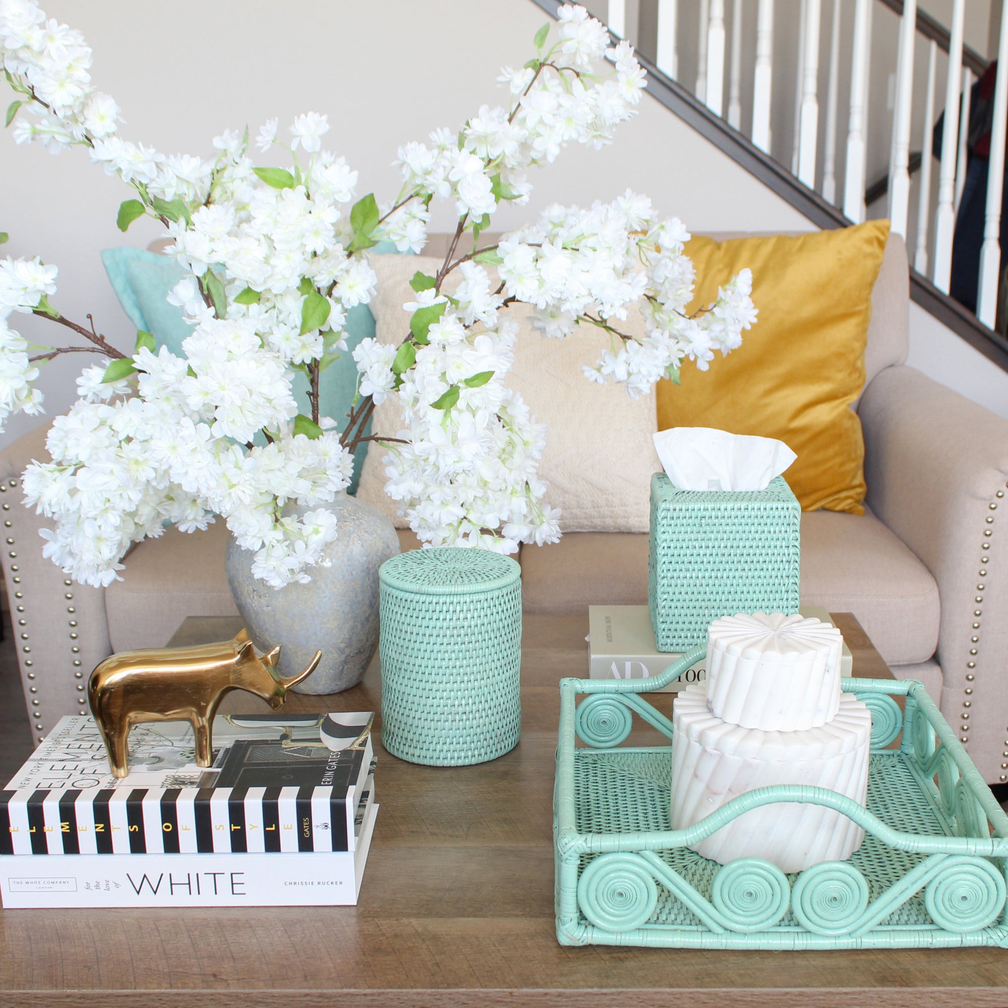 ECO HANDCRAFT sage green swirly rattan tray with tissue box and canister styled on a modern coffee table with floral decor