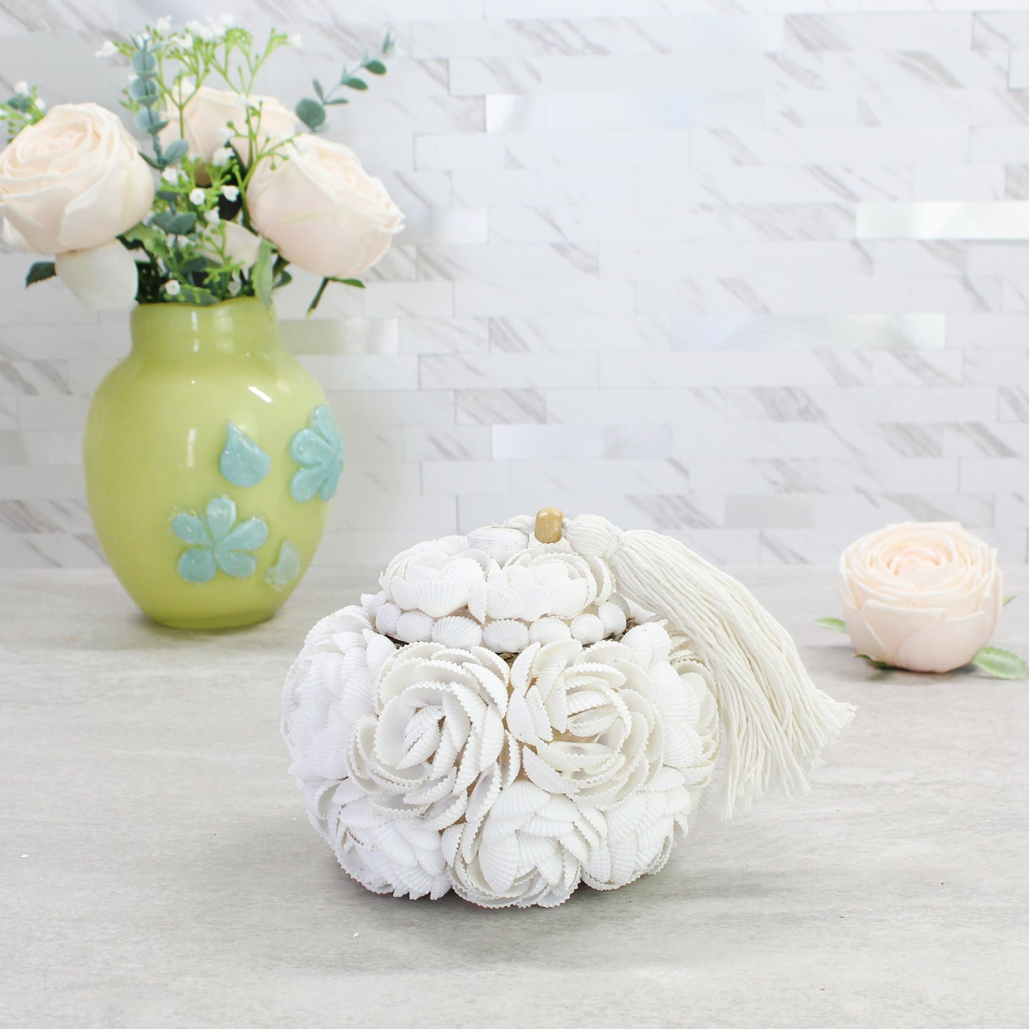 Medium artisan-crafted seashell rose storage box with tassel and wood accent, handmade from natural shells for coastal-inspired decorative storage.